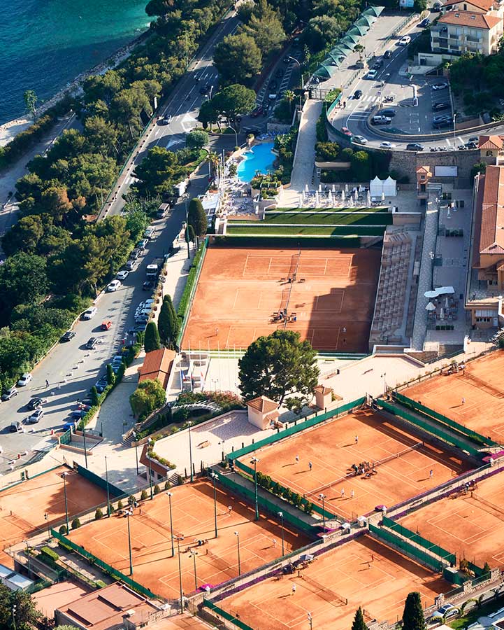 Panoramic views of tennis courts by the sea.