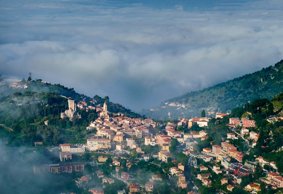 Panoramic view of the mountainous city with clouds above.