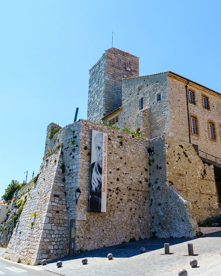 A small castle with a blue sky in the background.