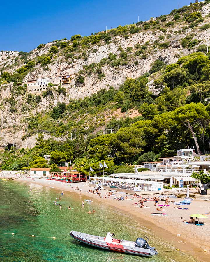 The mountain and people on the beach.