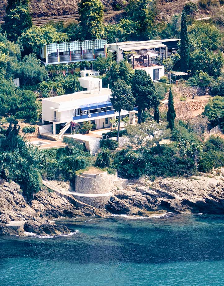 A house on the hilly coast next to the sea.