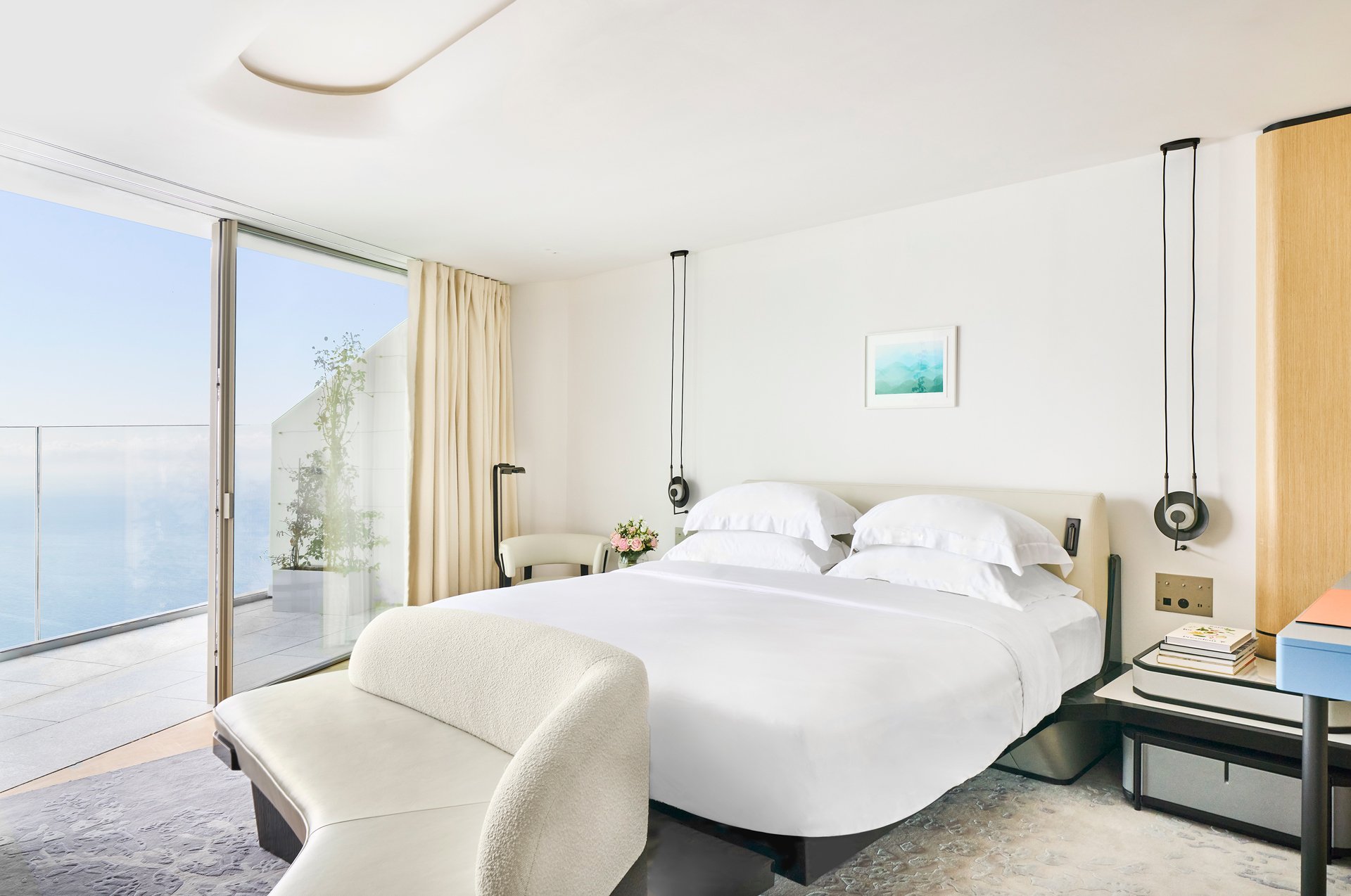 A spacious queen bed with ocean views in the Panoramic Room.
