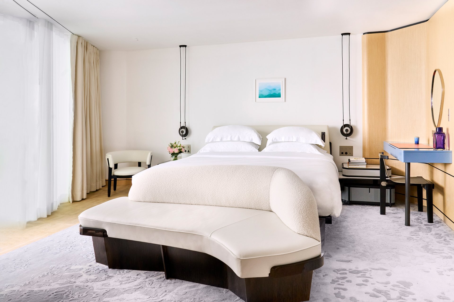 A spacious queen bed
on a grey carpet in the Panoramic Room.
