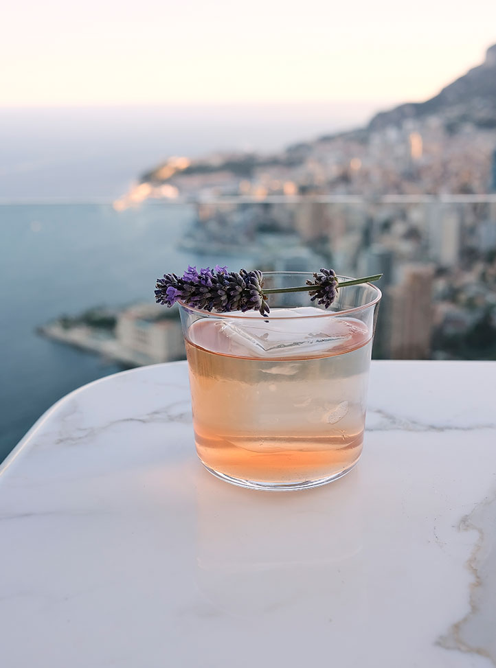 Bar Ceto at The Maybourne Riviera - Mocktail in glass with lavender stem on glass, put on a table with view onto the Riviera 