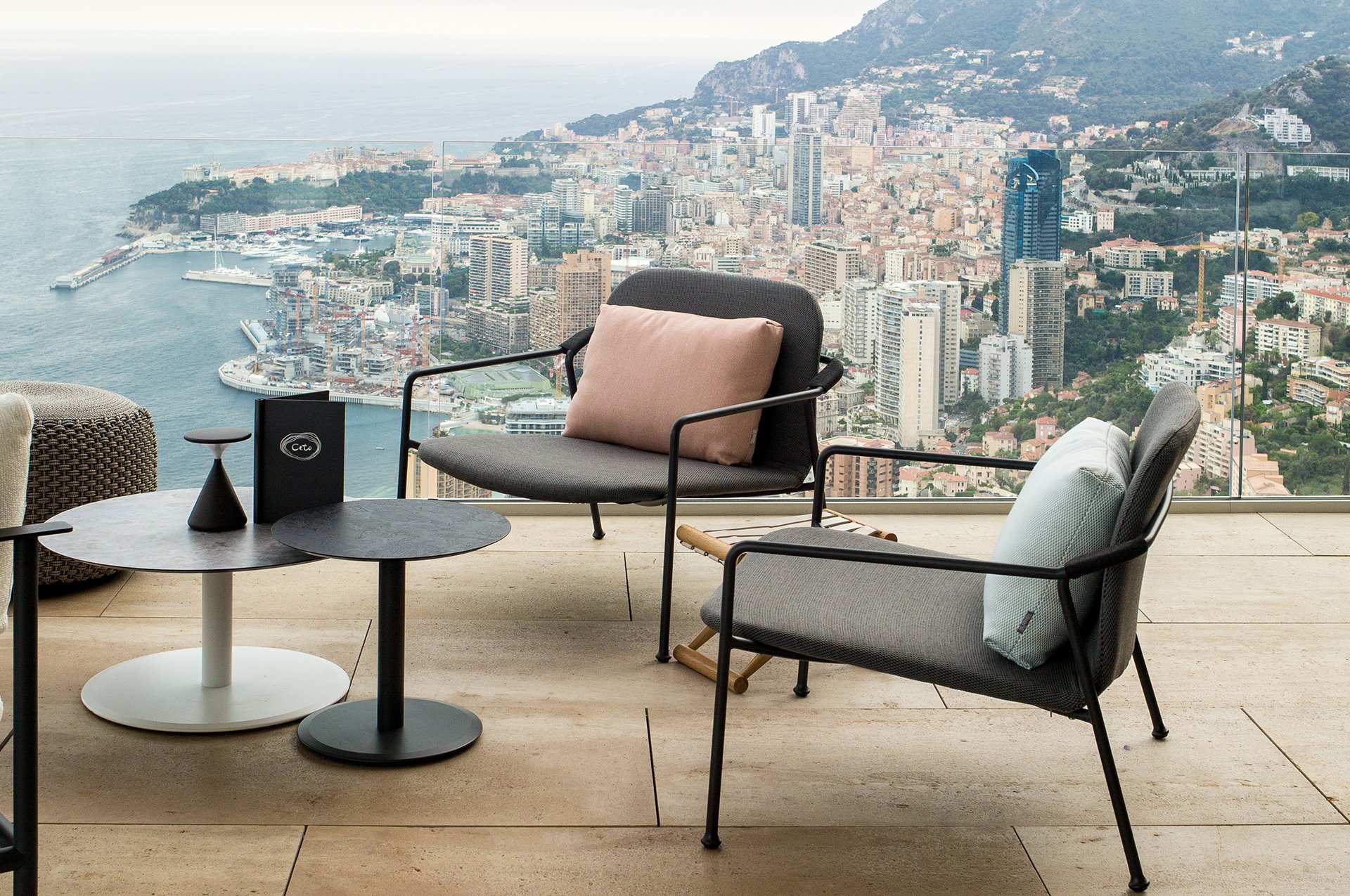 Bar Ceto at The Maybourne Riviera - two lounge chairs and two round coffee tables on the terrace with a view of Monaco.
