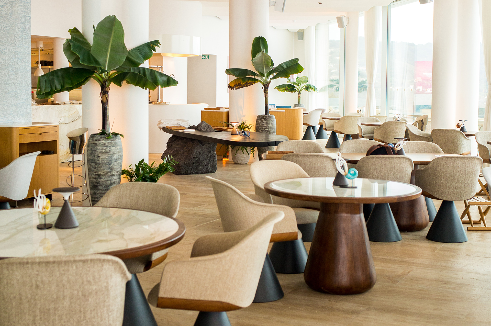 Bar Ceto at The Maybourne Riviera - view of the inside of the bar with table and armchairs and plants.