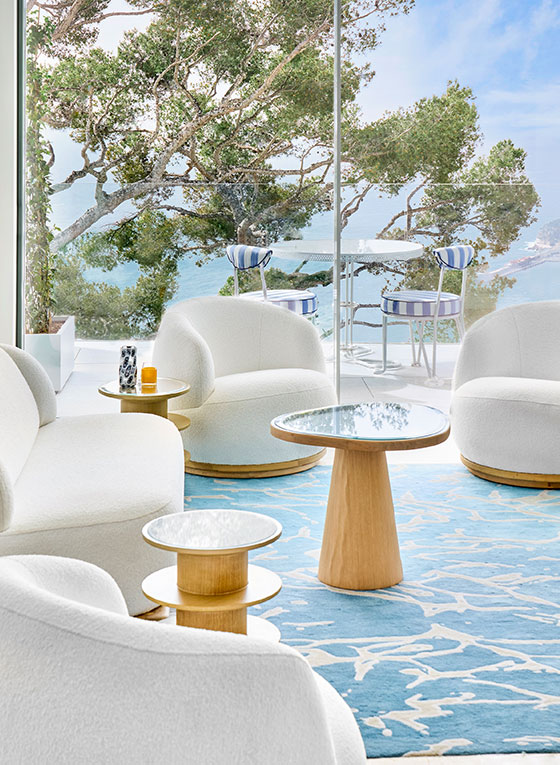 Corniche Suite at The Maybourne Riviera - Lounge with sofas, coffee table and terrace view with table and chairs on the terrace