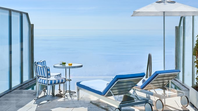 A terrace with a private pool, two sun loungers, a table with two chairs on each side at the Duplex Pool Suite at The Maybourne Riviera.