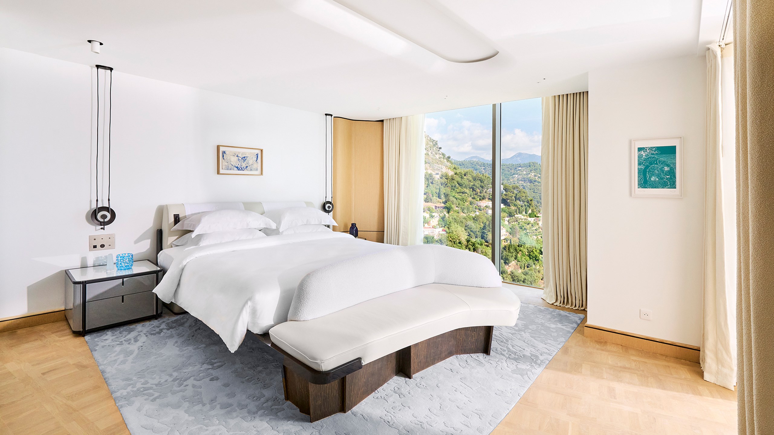 Grand Riviera Suite - bedroom with bed and floor to ceiling window.