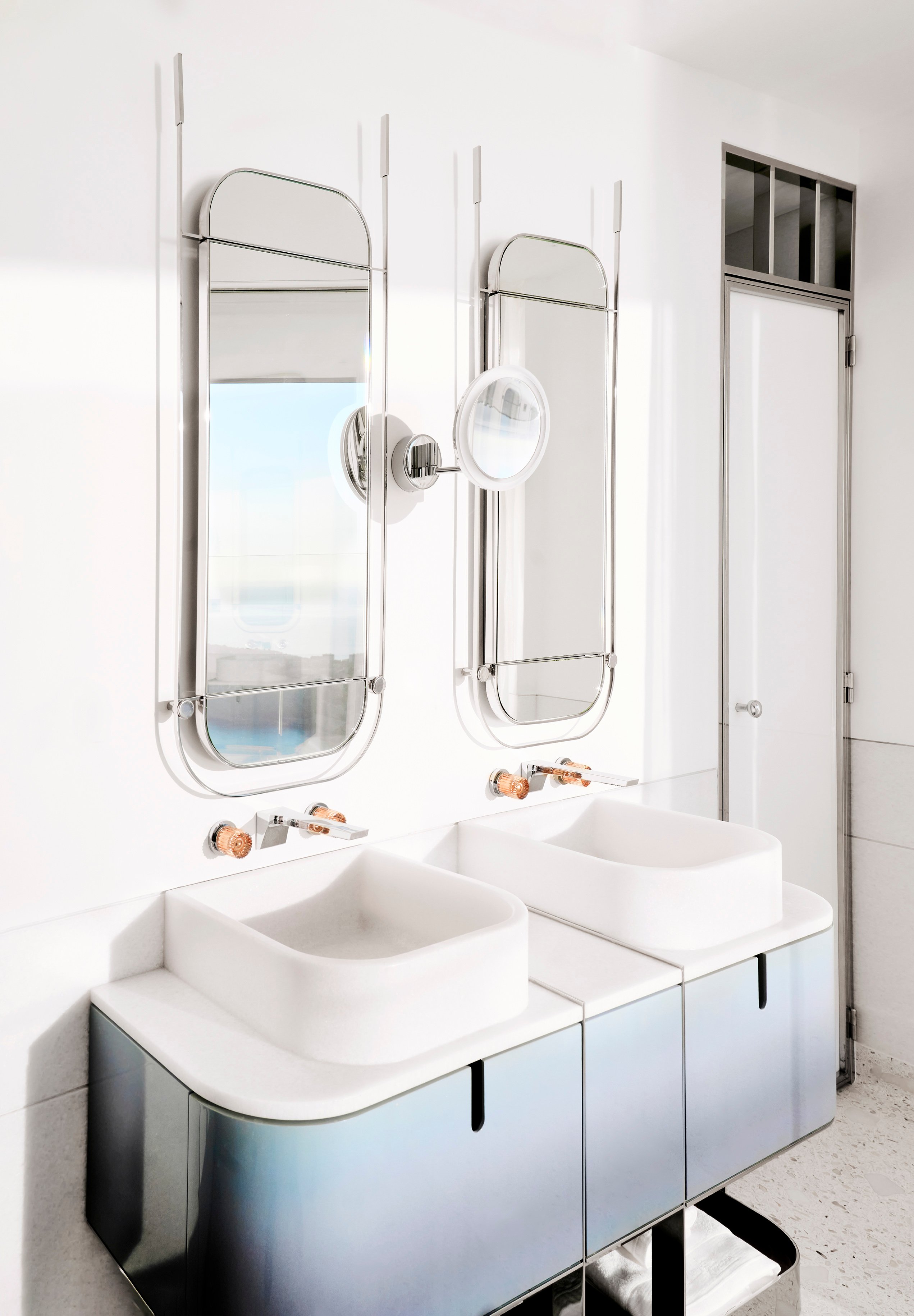 The Maybourne Riviera - Bathroom photo with two sinks and mirrors on the wall.