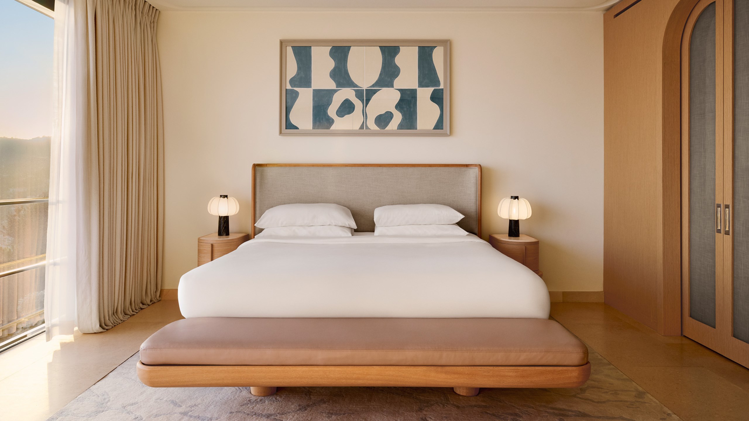 Modern bedroom with neutral tones, soft lighting and abstract wall art.