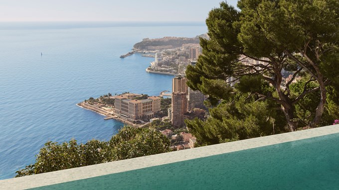 Infinity pool with panoramic view over coastal city and blue sea.