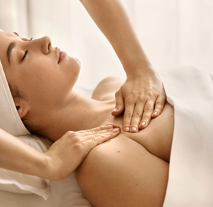 Woman having a Augustinus Bader treatment massage on neck and shoulder