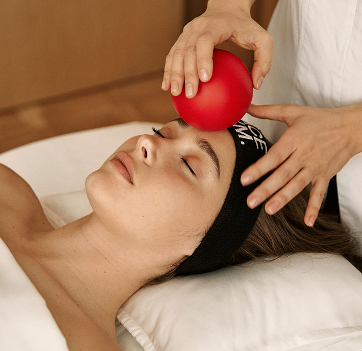 Woman having a FaceGym Workout Treatment with a ball
