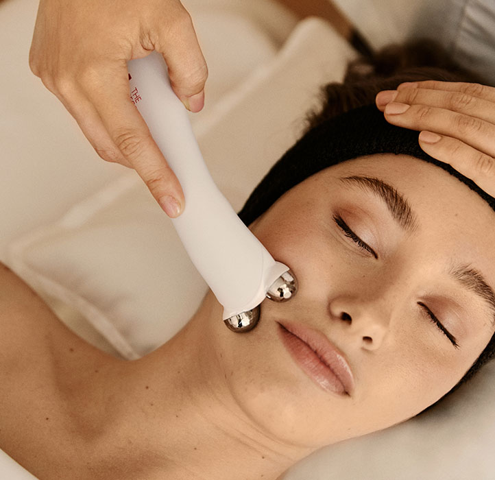 Woman having a FaceGym Workout treatment on face with roller application