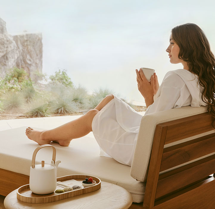 The Maybourne Riviera Spa - Model Having a Cup of Tea Laying on a Chair