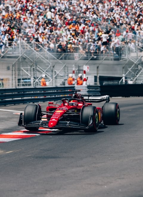 Ferrari Formula 1 on the track of Monaco Grand Prix in front of a crowd of spectators