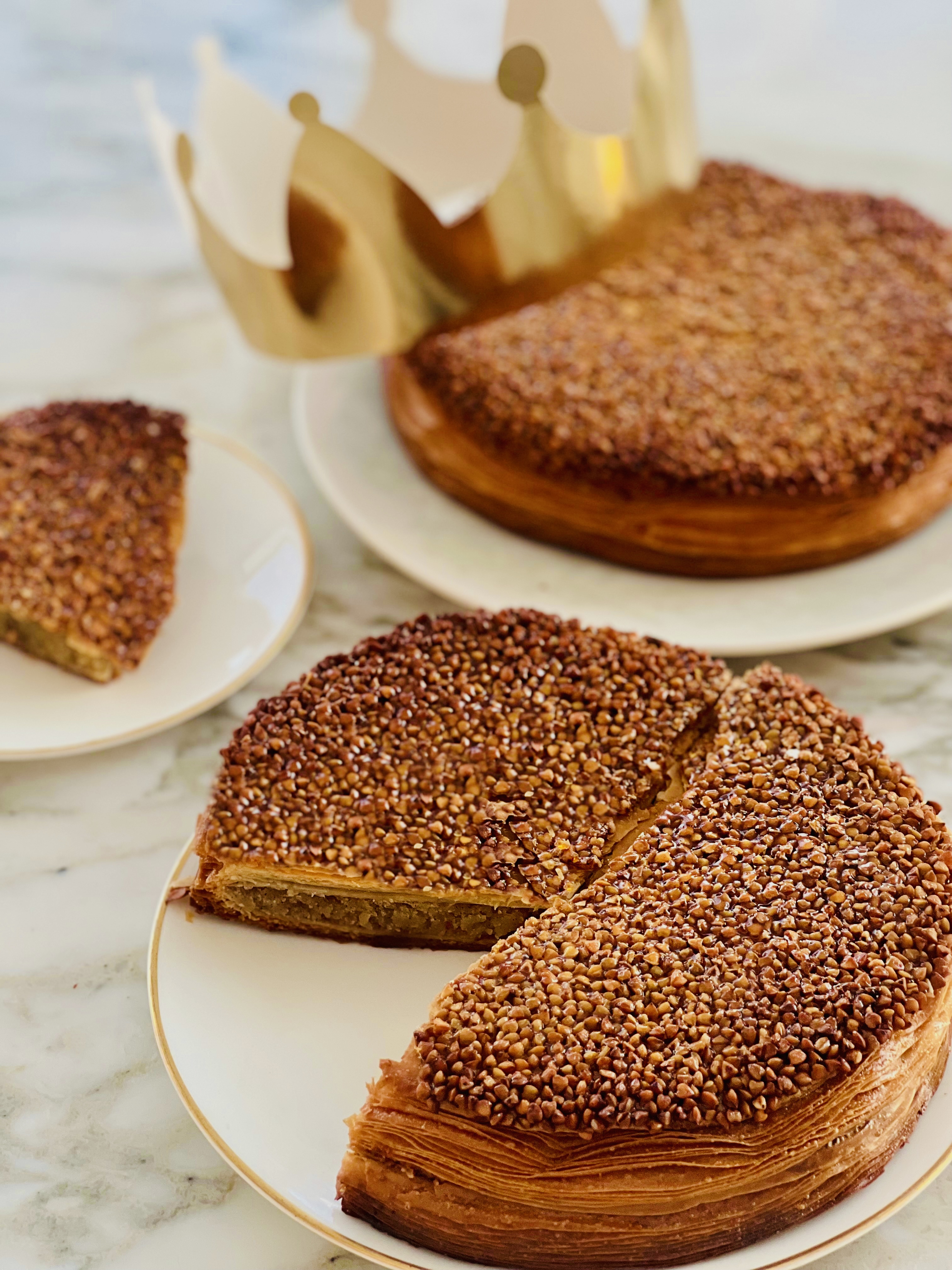 Galette des rois cakes with one slice cut out to show the inside